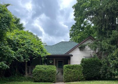 A home in Bloomington, Indiana surrounding by trees trimmed by Anthony's Lawncare