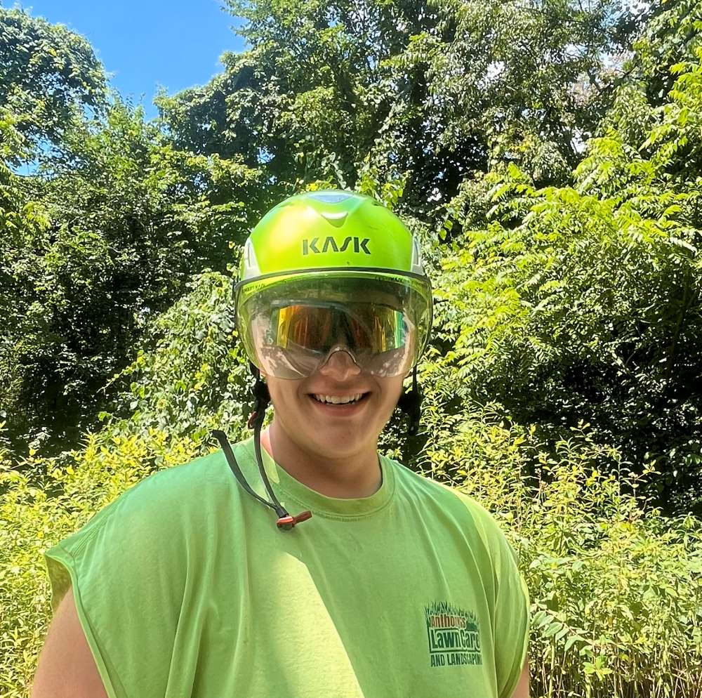 One of the team members of Anthonys Tree Removal in hard hat and protective glasses