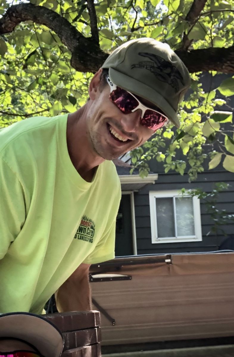 A smiling employee of Anthonys Landscaping and Tree Service